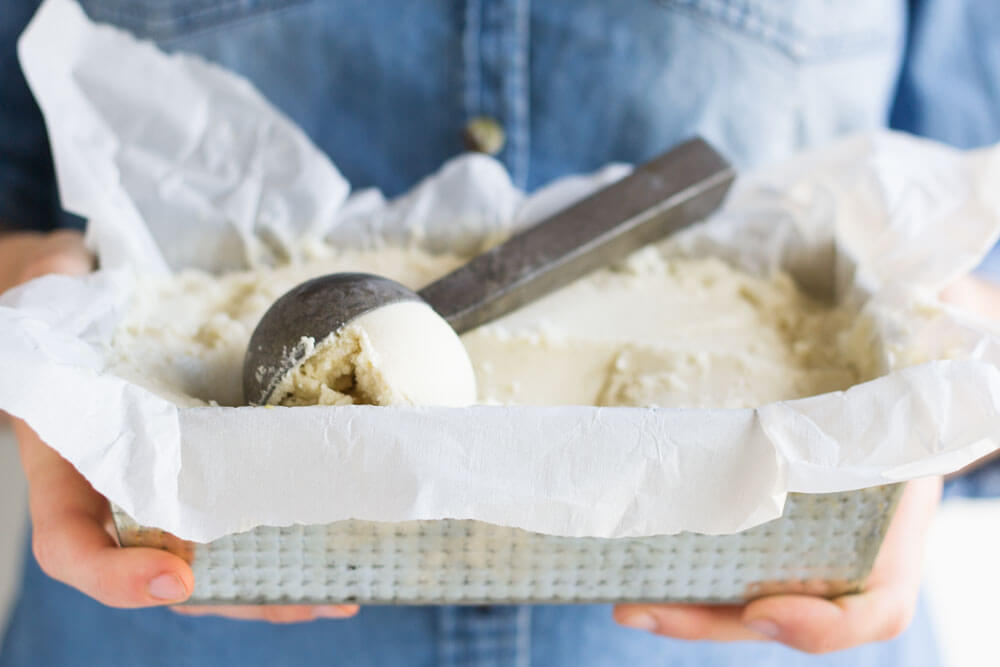 hands holding silver tray with ice cream