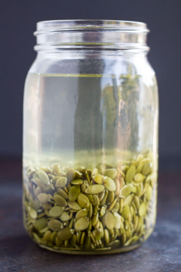 jar with pumpkin seeds soaking in it
