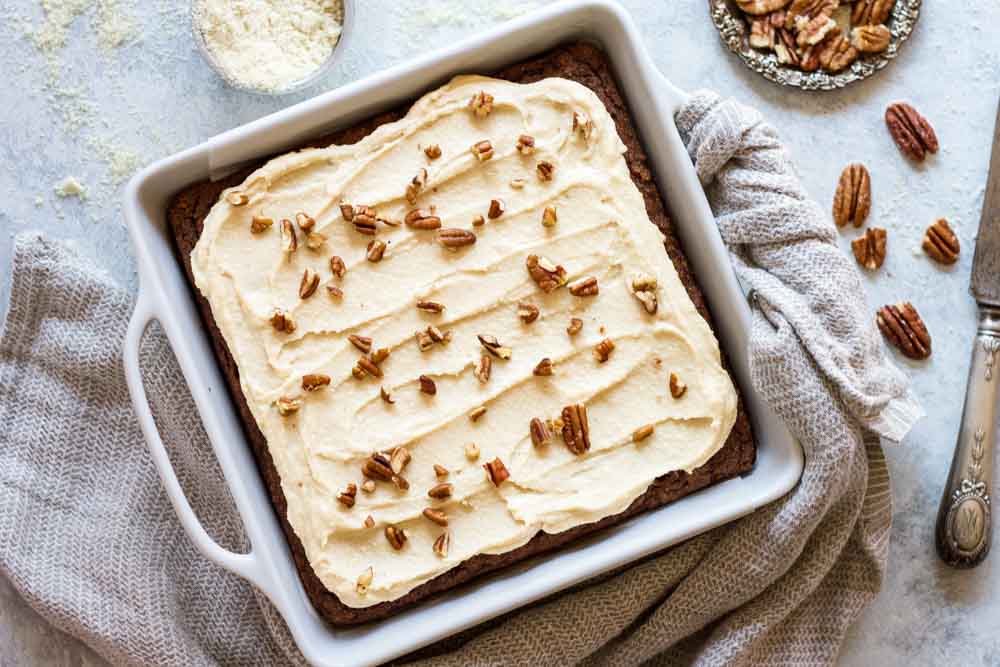 cake with white frosting in white baking tray