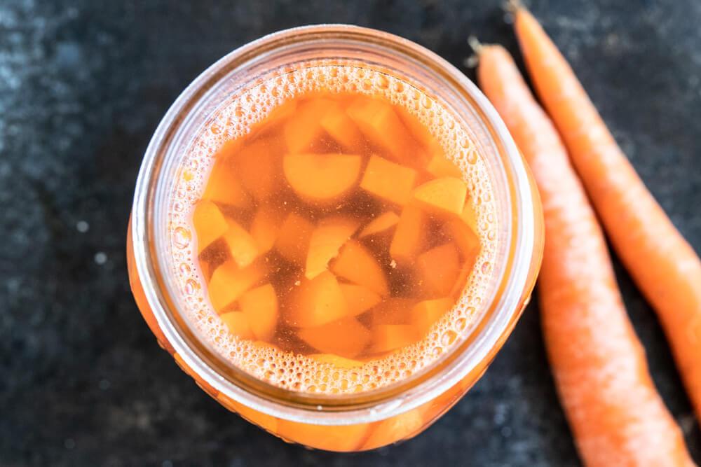top view inside a mason jar with fermented acrrots