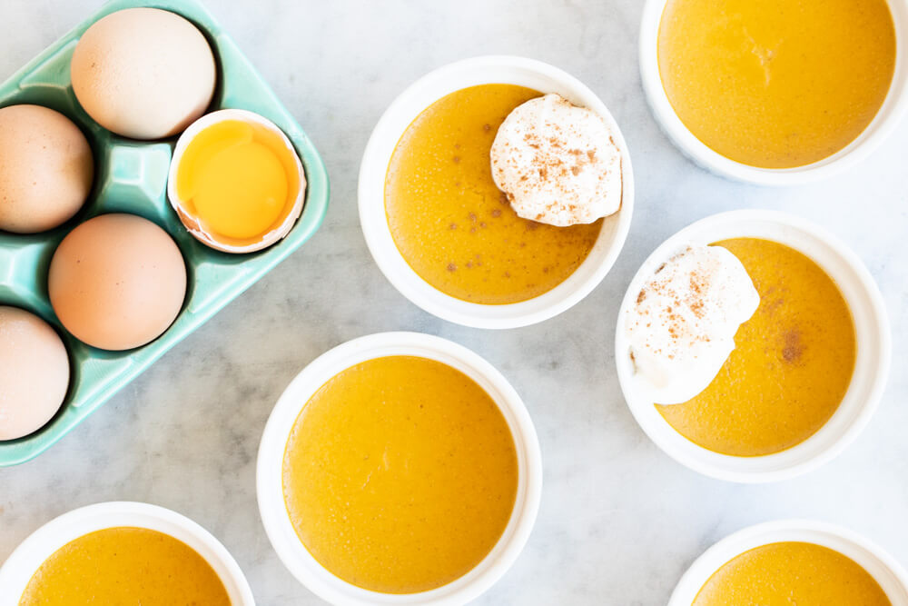 six small bowls of pumpkin custard