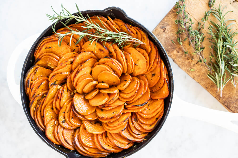 sweet potato slices in white skillet