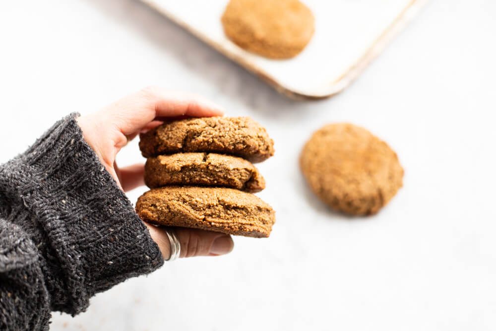 hand holding three gingerbread cookies