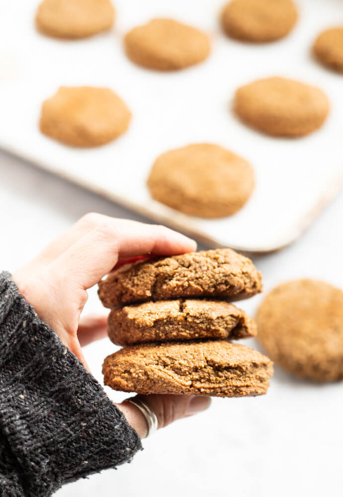 three big gingerbread cookies held in hand