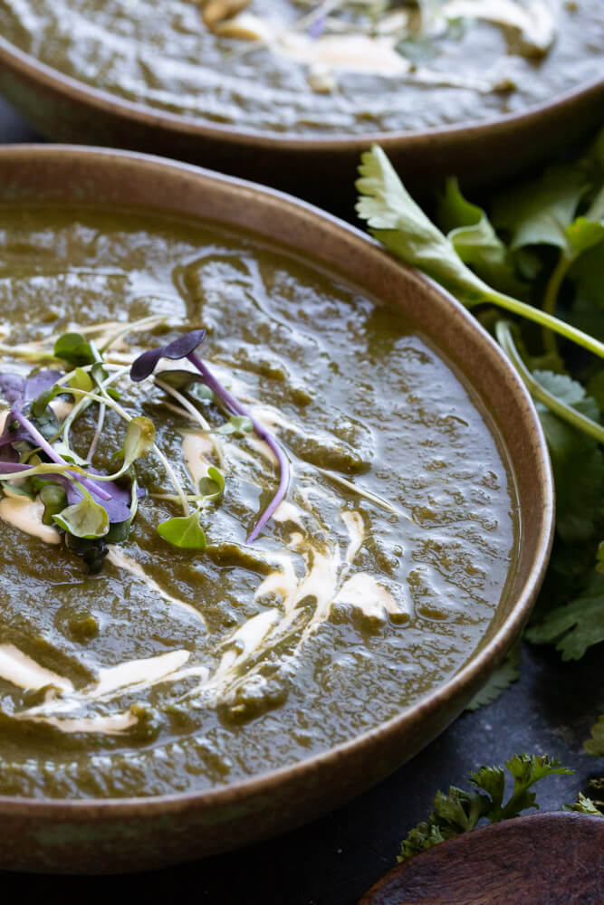 close up of detox green soup in green bowl