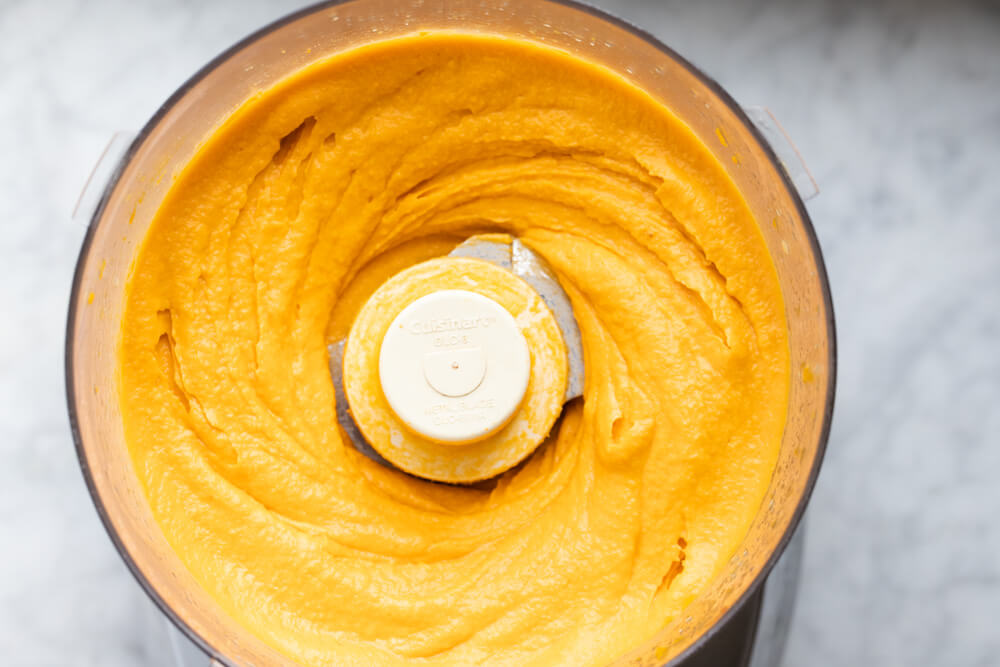 food processor with sweet potato hummus in it