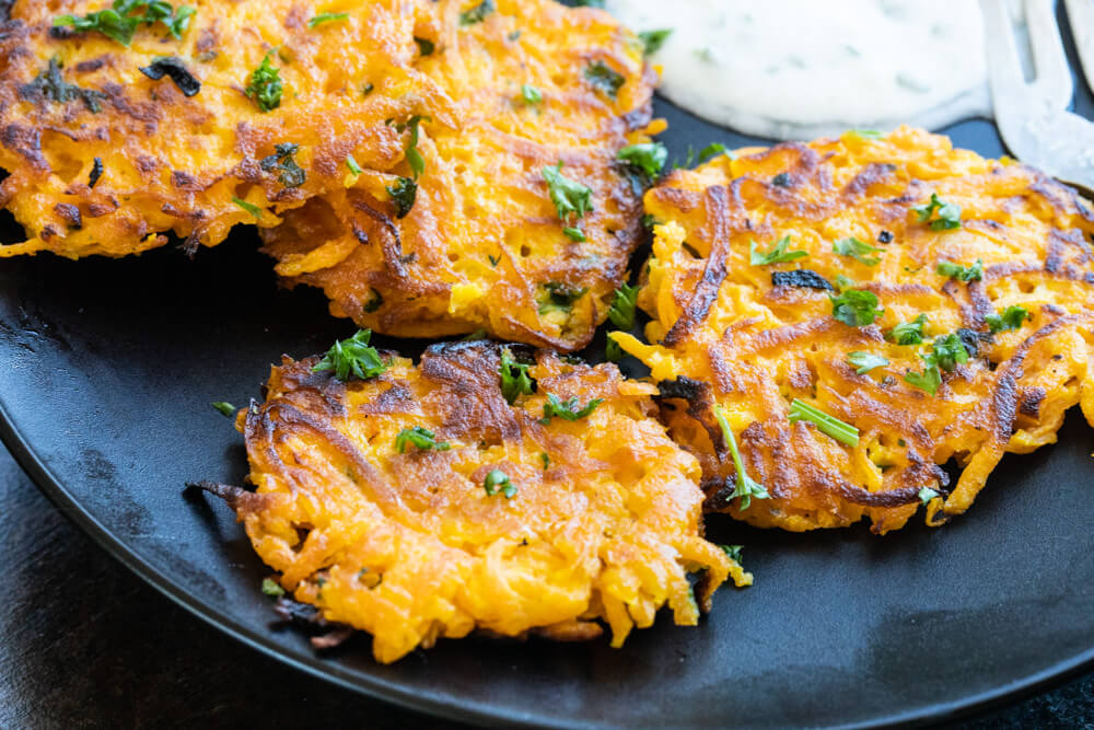 black plate with butternut squash fritters