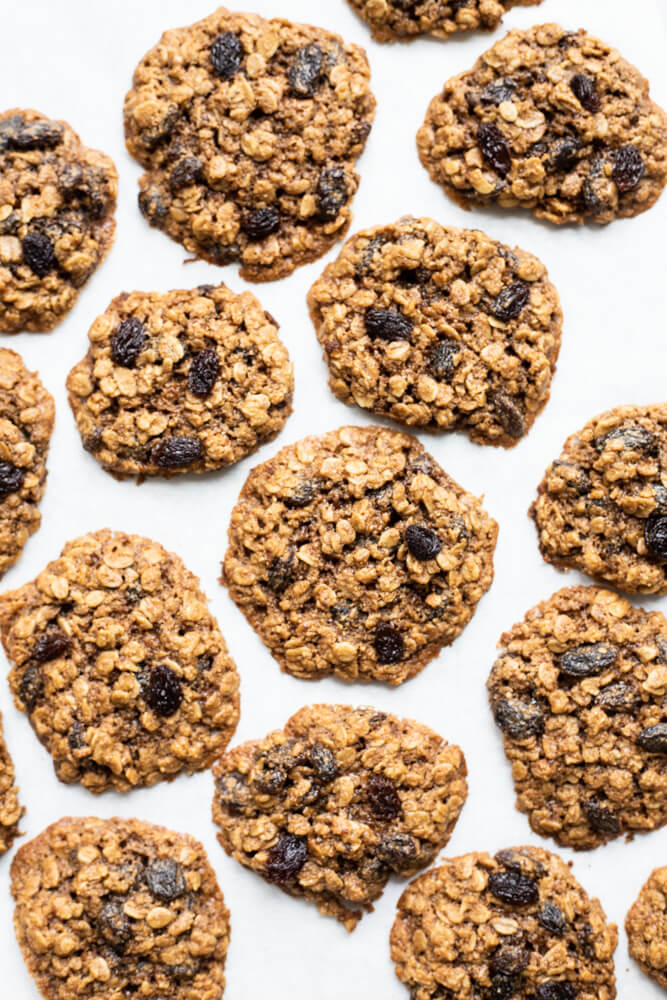 several gluten free oatmeal raisin cookies on white surface