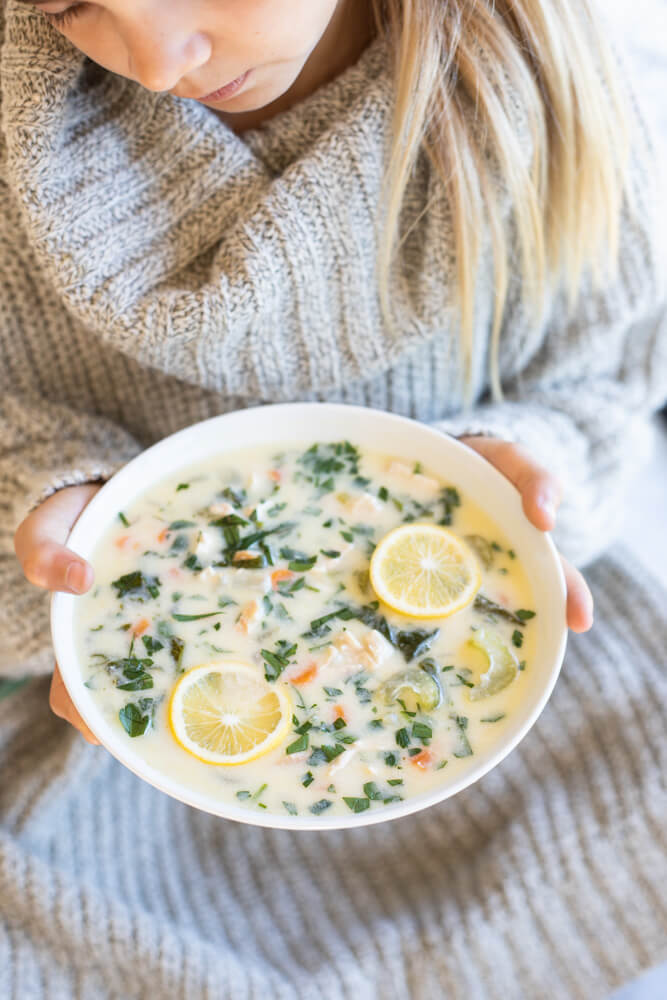 child holding bowl of soup