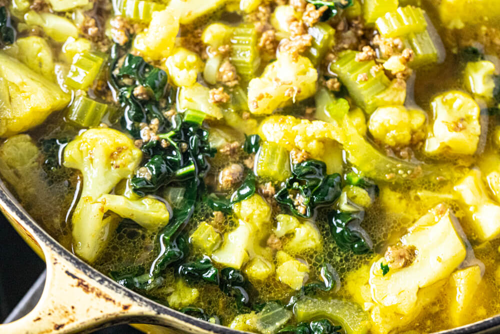 close up of soup in yellow pot
