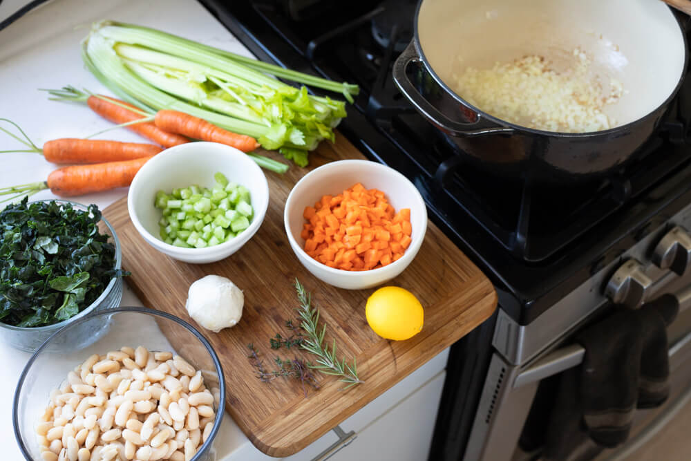chopped vegetables and a black pot for soup