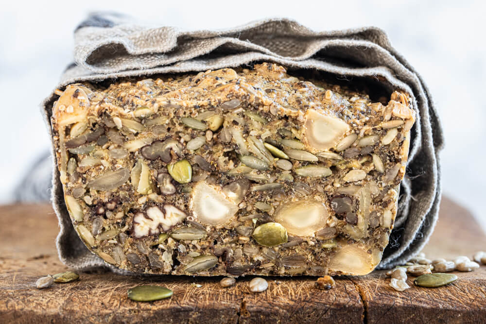 nut and seed bread wrapped in grey dish towel