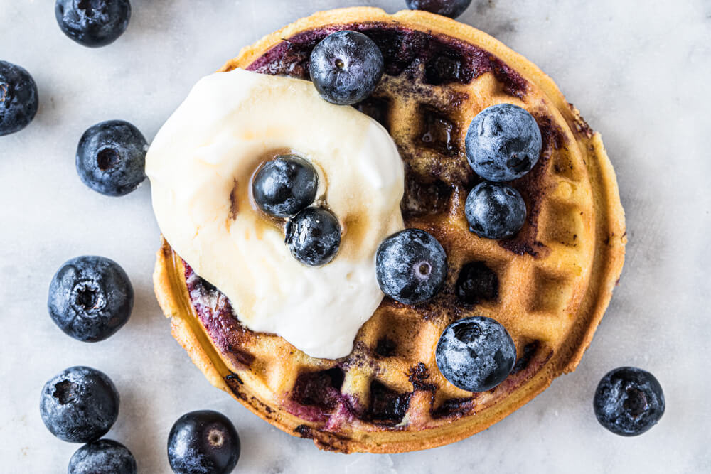 close up of mini waffle with whipped cream