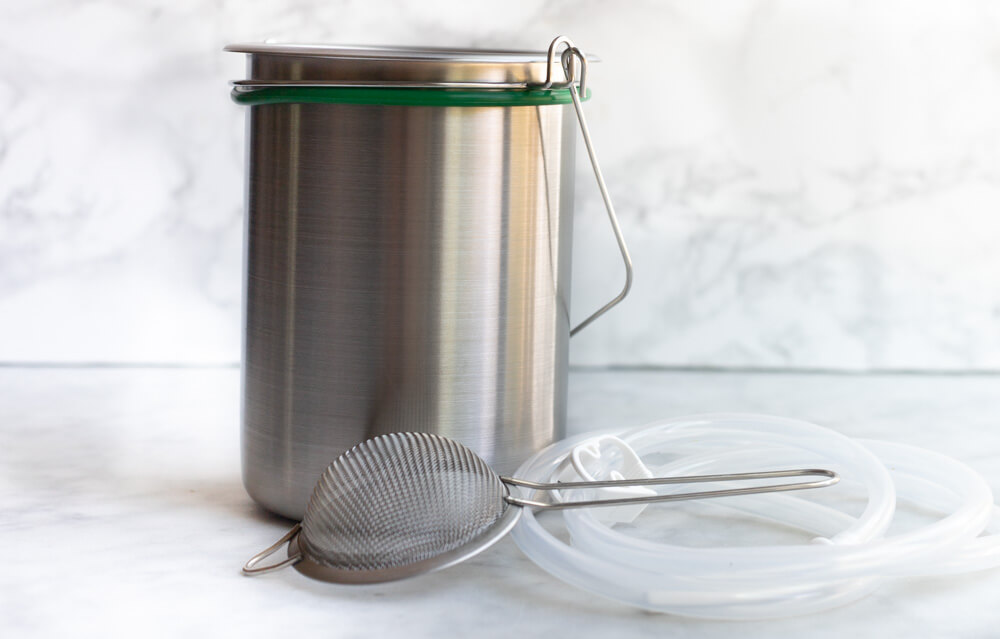 stainless enema bucket on white counter