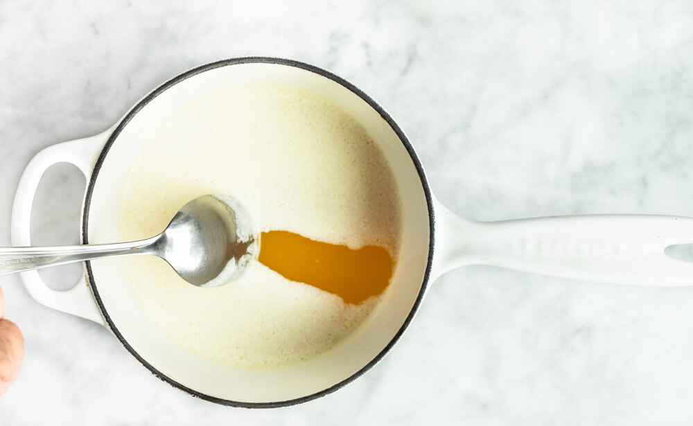 spoon in pot of melted butter