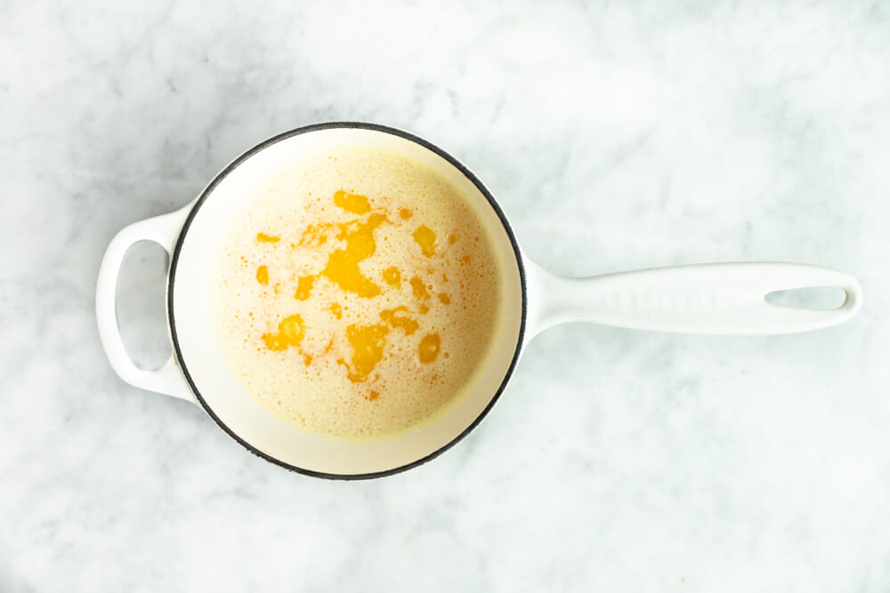 white pot of simmering ghee