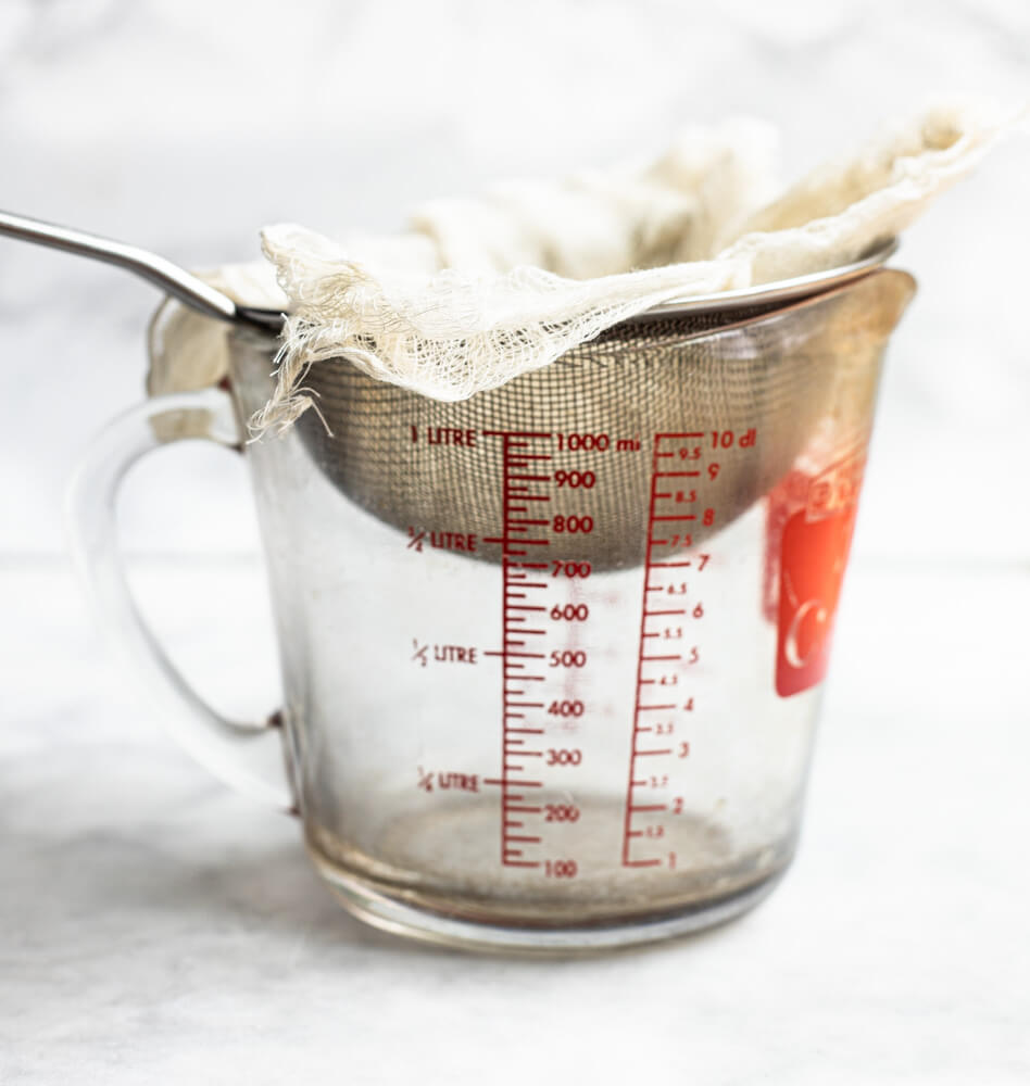 strainer with cheesecloth inside it