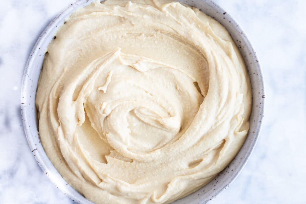 hummus in a speckled bowl