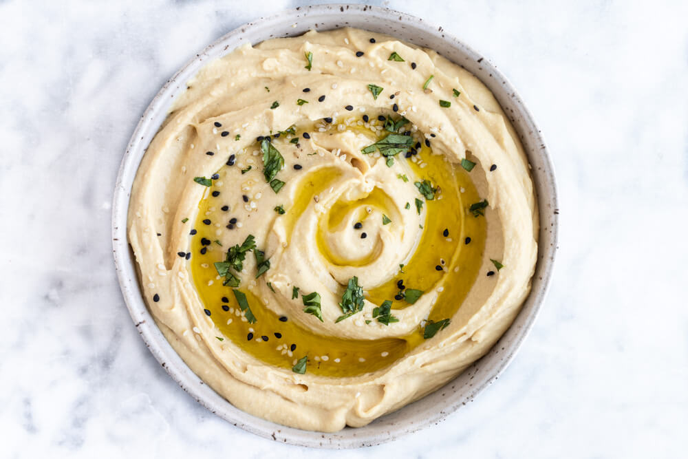 red lentil hummus in white bowl