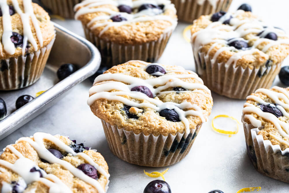 blueberry muffins with a white drizzle on top