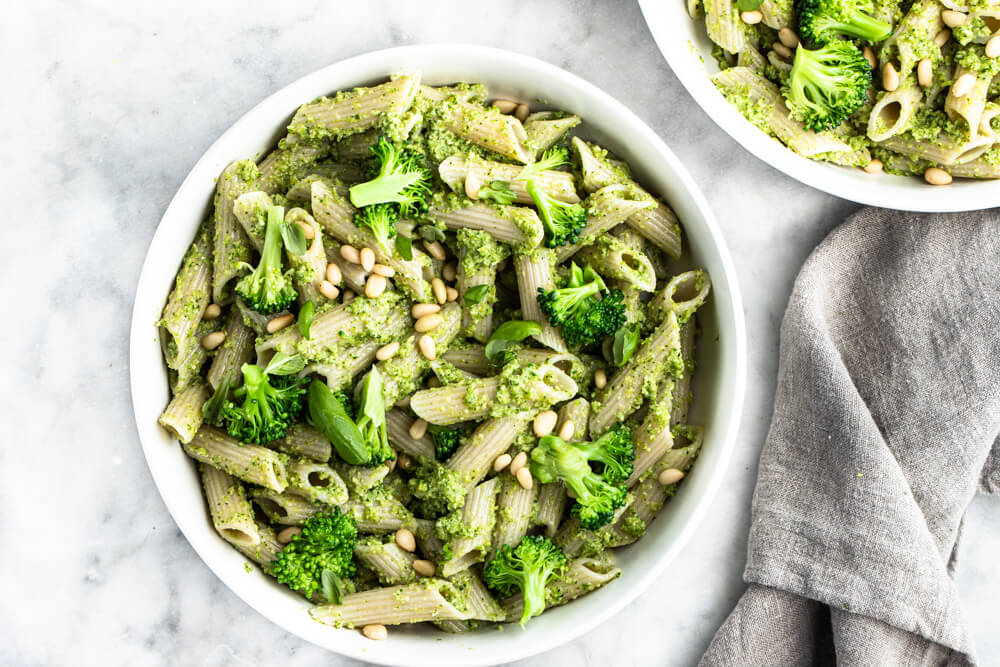 pesto pasta dish in white bowl