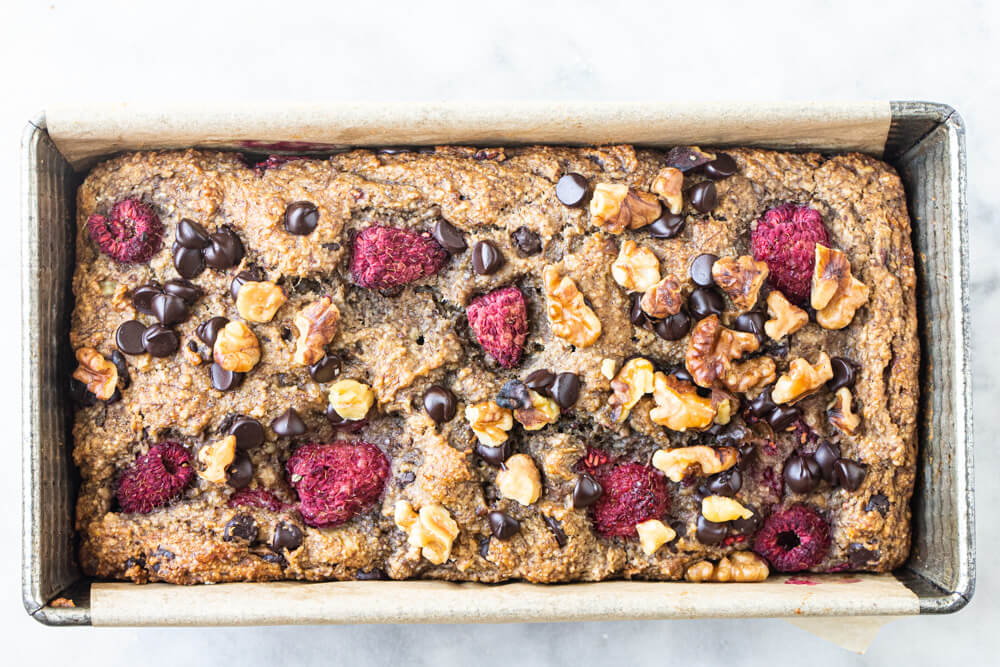 close up of raspberry chocolate chip banana bread in metal tin