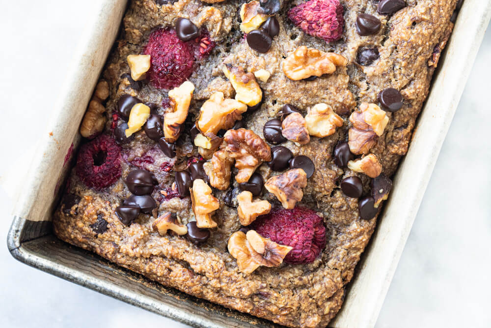 raspberries and chocolate chips on top of banana bread