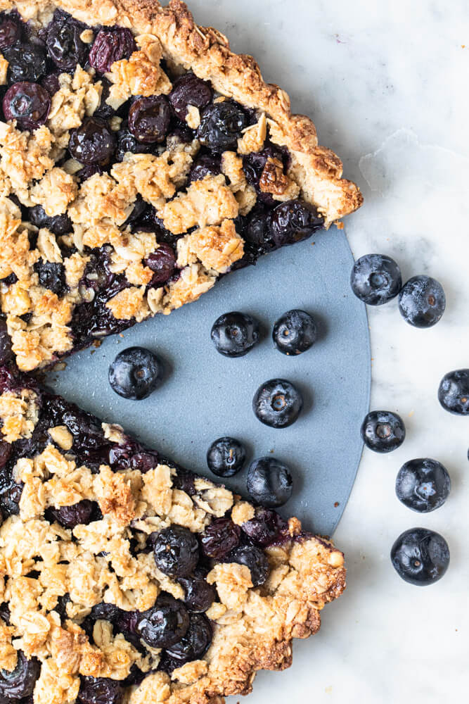 blueberry pie with one slice cut out