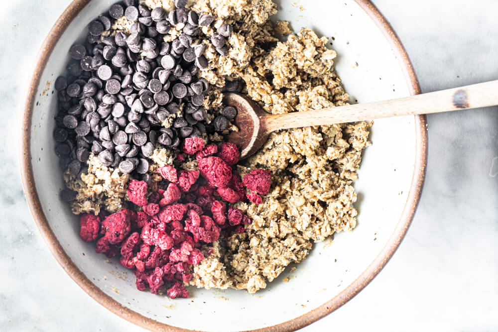 while bowl with oats and raspberries in it