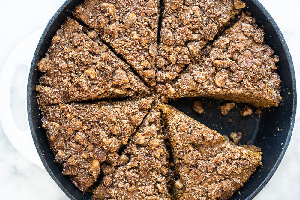 white skillet with pumpkin cake