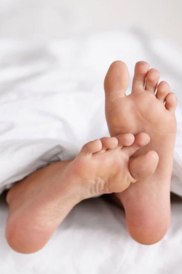 feet peeking out from under blanket