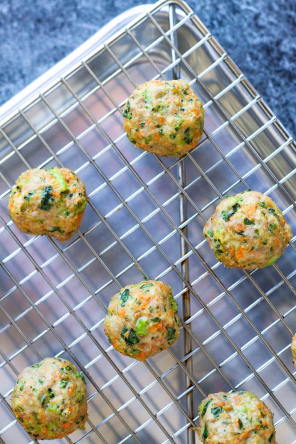 four veggie turkey meatballs on baking sheet