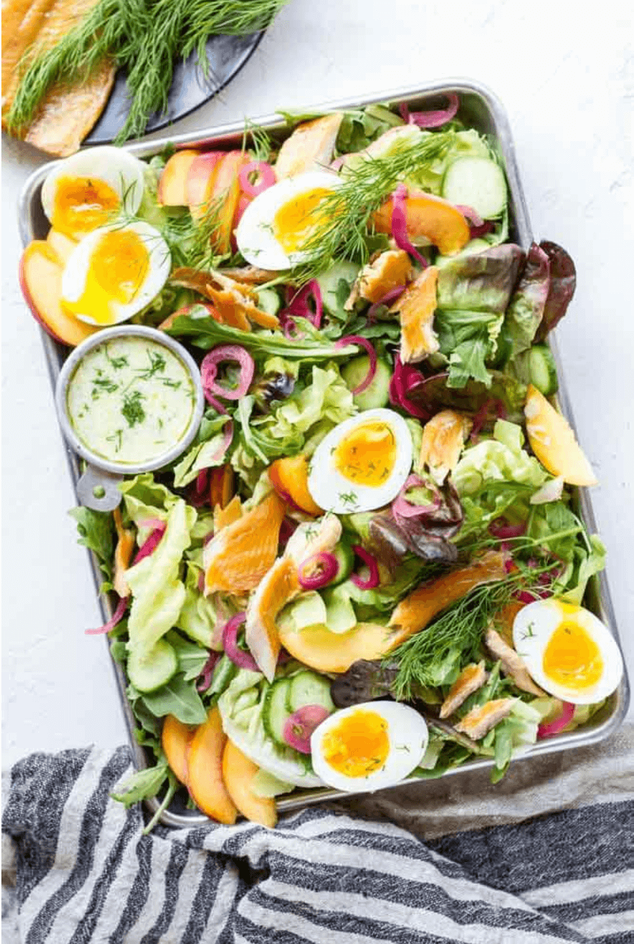 smoked trout salad on metal tray with stripped towel